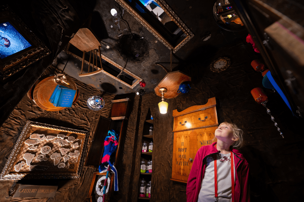Girl looking around the rabbit hole