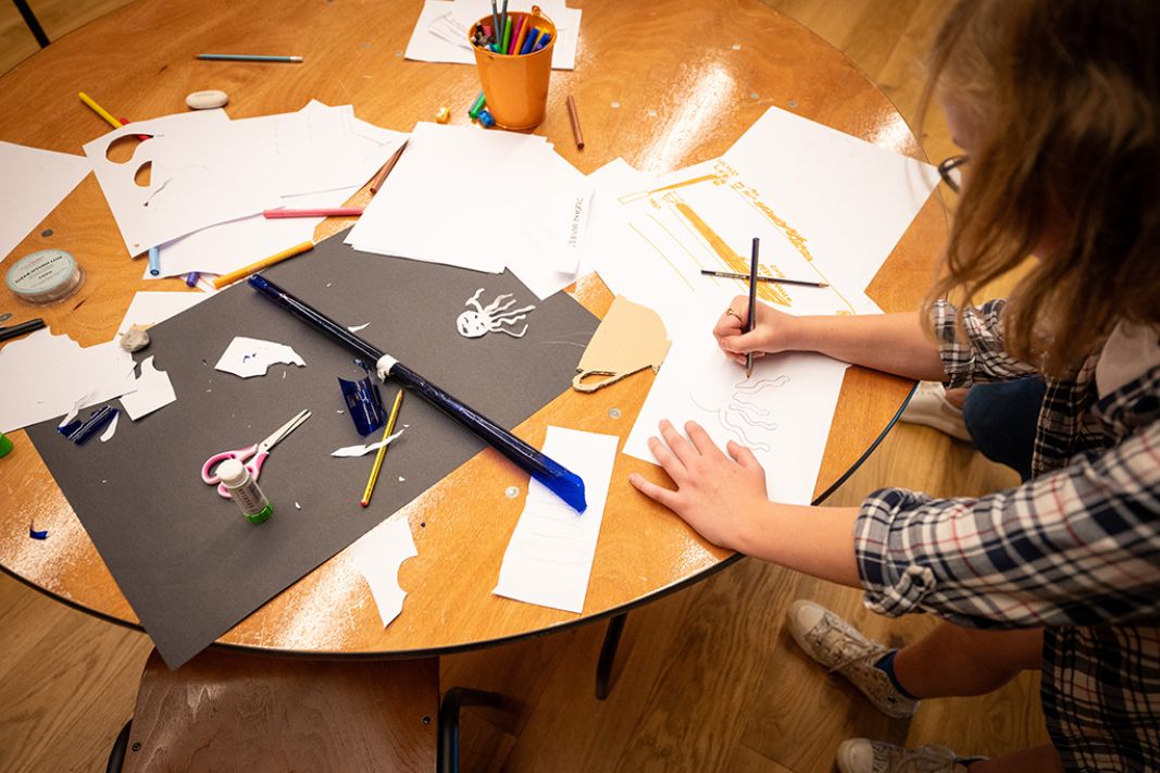 Person doing craft activity at a table