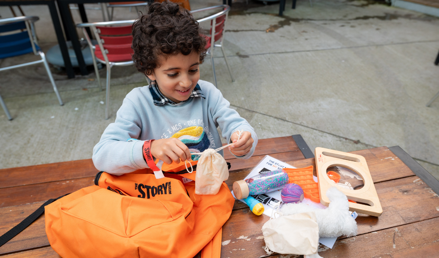 A child unpacking a sensory backpack
